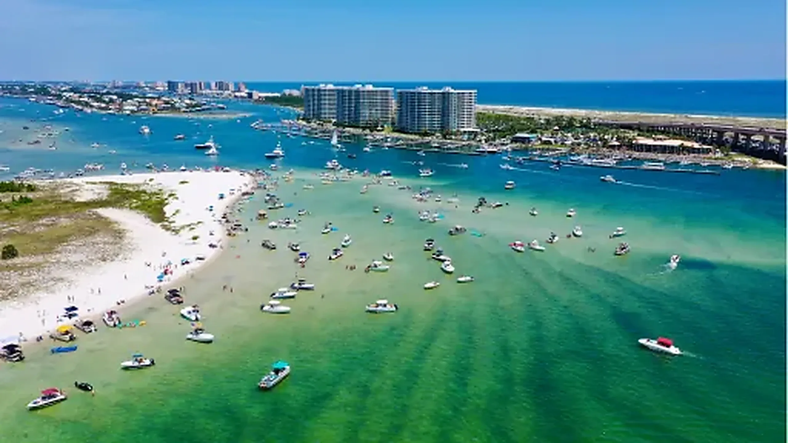 Boats anchored in the clear shallow pass off the Alabama and Florida gulf coast